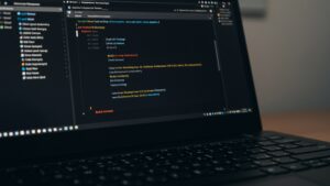 Photorealistic laptop with cloud deployment terminal open, showing build success, live URL, and Docker or Kubernetes CLI commands by pixlelo.com Variation 93